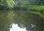 The river opens into a small dammed pond near a private home.