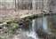 Stonework along the river near a former carriage bridge and near a cabin.